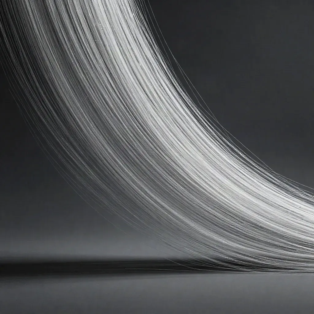 Silver light filaments converge into a white bloom in dark graphite haze.